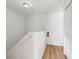 Bright hallway with a white staircase and wood floors, offering a clean and modern aesthetic at 412 Verona Ave, Davenport, FL 33897