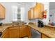 Functional kitchen featuring stainless steel appliances, granite countertops, and a window view at 412 Verona Ave, Davenport, FL 33897