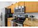 Well-equipped kitchen with stainless steel appliances, granite counters, and ample storage at 412 Verona Ave, Davenport, FL 33897