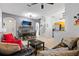 Open-concept living area featuring a comfortable sofa, modern lighting, and access to the kitchen at 412 Verona Ave, Davenport, FL 33897