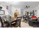 Open living space with kitchen view, modern lighting, dining table, and comfortable couches at 412 Verona Ave, Davenport, FL 33897