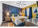 Well-designed bedroom featuring decorative wallpaper, a ceiling fan, and ample natural light at 4161 Paragraph Dr, Kissimmee, FL 34746