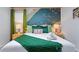 Inviting bedroom featuring an accent wall, cozy bedding, and warm lighting for a peaceful and comfortable stay at 4161 Paragraph Dr, Kissimmee, FL 34746