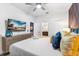 Comfortable bedroom with a TV, ceiling fan, and ensuite bathroom access at 4161 Paragraph Dr, Kissimmee, FL 34746