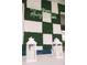 Neon 'Home away from home' sign surrounded by decorative plant squares on a white wall at 4161 Paragraph Dr, Kissimmee, FL 34746