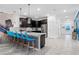 Bright, modern kitchen with stainless steel appliances and a spacious island with bar seating at 4161 Paragraph Dr, Kissimmee, FL 34746