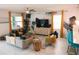 Bright living room with a large TV, comfortable sofas, and colorful accents, ideal for relaxing at 4161 Paragraph Dr, Kissimmee, FL 34746