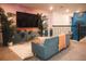 Cozy living space featuring a large-screen TV, stylish furniture, and a mural with relaxing palm tree silhouettes at 4161 Paragraph Dr, Kissimmee, FL 34746