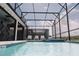 Large screened-in pool and jacuzzi with ample space to relax and soak up the sun in the outdoor living space at 4161 Paragraph Dr, Kissimmee, FL 34746