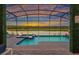 Beautiful screened pool with a lake view, perfect for relaxing and entertaining guests at 4161 Paragraph Dr, Kissimmee, FL 34746