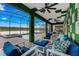 Outdoor seating area with a clear view to a large pool and beautiful lake in the distance, all under a screened enclosure at 4161 Paragraph Dr, Kissimmee, FL 34746