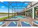 This screened-in pool features a spa, lake view and is surrounded by lounge chairs for relaxing in the sun at 4161 Paragraph Dr, Kissimmee, FL 34746