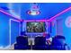 Modern theater room with comfortable seating, large screen, and themed decorations at 4161 Paragraph Dr, Kissimmee, FL 34746