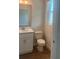 Stylish half bathroom features a modern vanity with quartz countertop, white cabinets, and wood-look tile flooring at 446 Scotsmans Pl, Debary, FL 32713