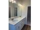 Bathroom with double vanity, quartz countertop and tile flooring at 446 Scotsmans Pl, Debary, FL 32713
