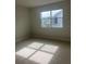 Bright bedroom with neutral carpet, large window, and ample natural light at 446 Scotsmans Pl, Debary, FL 32713