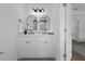Double vanity bathroom featuring large mirrors, modern fixtures, and white cabinets at 523 W Princeton St # 1, Orlando, FL 32804
