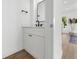 Elegant half bath with white vanity, dark hardware, and modern fixtures at 523 W Princeton St # 1, Orlando, FL 32804