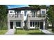 New construction two-story home featuring modern architecture, balconies, and a landscaped front yard at 523 W Princeton St # 1, Orlando, FL 32804