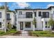 Modern two-story home with a white exterior, black trim, and a small balcony at 523 W Princeton St # 1, Orlando, FL 32804