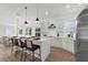 Open kitchen with island seating, modern appliances, and hardwood floors at 523 W Princeton St # 1, Orlando, FL 32804