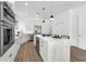 Bright kitchen featuring an island with marbled countertop, stainless steel appliances, and wooden floor at 523 W Princeton St # 1, Orlando, FL 32804