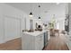 Open kitchen featuring a large island with bar seating, modern lighting, and sleek appliances at 523 W Princeton St # 1, Orlando, FL 32804