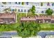 Aerial view showing the condo complex's parking, landscaping, and proximity to the street at 5545 Devonbriar Way # 206, Orlando, FL 32822