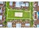 Aerial view of townhome roofs and courtyard, featuring a sand volleyball court and walkways at 5545 Devonbriar Way # 206, Orlando, FL 32822
