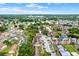 An aerial view of condos showcasing lush landscaping, convenient parking, and a well-maintained community at 5545 Devonbriar Way # 206, Orlando, FL 32822