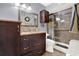 Updated bathroom featuring a modern vanity, stylish mirror, and sleek glass-enclosed shower for a spa-like experience at 5545 Devonbriar Way # 206, Orlando, FL 32822