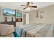 Comfortable bedroom with a ceiling fan, decorative fireplace, and streaming television at 5545 Devonbriar Way # 206, Orlando, FL 32822