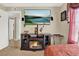 Comfortable bedroom featuring fireplace, flat screen tv, and a relaxing aesthetic at 5545 Devonbriar Way # 206, Orlando, FL 32822
