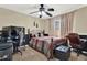 Bedroom with a wooden bed frame, ceiling fan, and computer desk at 5545 Devonbriar Way # 206, Orlando, FL 32822