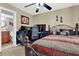 Spacious bedroom with wooden bed frame, ceiling fan, and a computer desk at 5545 Devonbriar Way # 206, Orlando, FL 32822