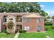 Inviting brick and siding townhouse with lush landscaping and charming curb appeal in a desirable neighborhood at 5545 Devonbriar Way # 206, Orlando, FL 32822