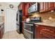 Contemporary kitchen showcasing modern appliances, granite countertops, and ample cabinet space at 5545 Devonbriar Way # 206, Orlando, FL 32822