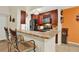 Beautiful kitchen with granite countertops, dark cabinetry, and modern stainless steel appliances and breakfast bar at 5545 Devonbriar Way # 206, Orlando, FL 32822
