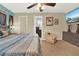 Relaxing main bedroom featuring a ceiling fan, ensuite bathroom access, and comfortable sitting area at 5545 Devonbriar Way # 206, Orlando, FL 32822