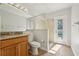 Bathroom with a single sink vanity, a glass door standing shower, and an outdoor exit at 604 Cheviot Ct, Apopka, FL 32712