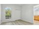 Bright bedroom with wood floor, window, closet, and connecting bathroom at 604 Cheviot Ct, Apopka, FL 32712
