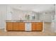 Kitchen with light wood cabinets, granite countertops, and a breakfast bar that opens to the living area at 604 Cheviot Ct, Apopka, FL 32712