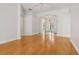 Spacious living room boasting hardwood floors and an archway to the glass front door at 604 Cheviot Ct, Apopka, FL 32712