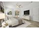 Bright main bedroom boasts a ceiling fan, flat screen tv, and sliding door access to the pool at 604 Cheviot Ct, Apopka, FL 32712