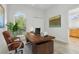 Office with hardwood desk, brown leather chair and a window with a view of the outdoors at 604 Cheviot Ct, Apopka, FL 32712