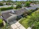An aerial view of the home, showcasing the roof, driveway, and landscaped surroundings at 676 Dunblane Dr, Winter Park, FL 32792
