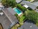 Aerial view highlighting the pool, lush backyard landscaping, and location within the neighborhood at 676 Dunblane Dr, Winter Park, FL 32792