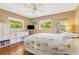 This bright bedroom includes hardwood floors, two windows, and stylish decor, offering a calming and inviting retreat at 676 Dunblane Dr, Winter Park, FL 32792
