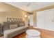 Cozy bedroom featuring hardwood floors, sofa, and a ceiling fan at 676 Dunblane Dr, Winter Park, FL 32792