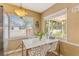 The quaint breakfast nook is lit naturally by a window overlooking a serene backyard at 676 Dunblane Dr, Winter Park, FL 32792
